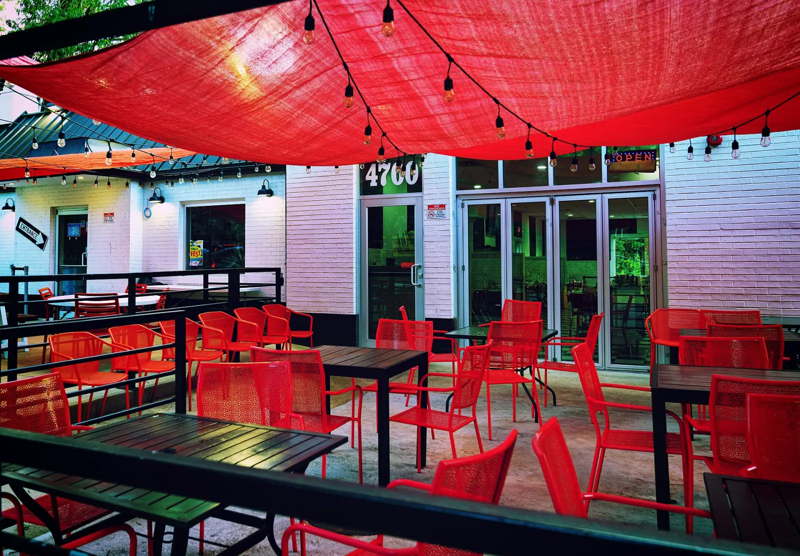 Tables and chairs on a sidewalk cafe patio. The photo was not taken in Fort Myers.