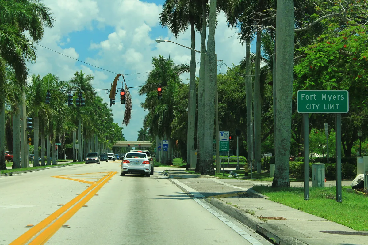 Power lines and traffic signals over McGregor Boulevard at the Fort Myers city limit sign.