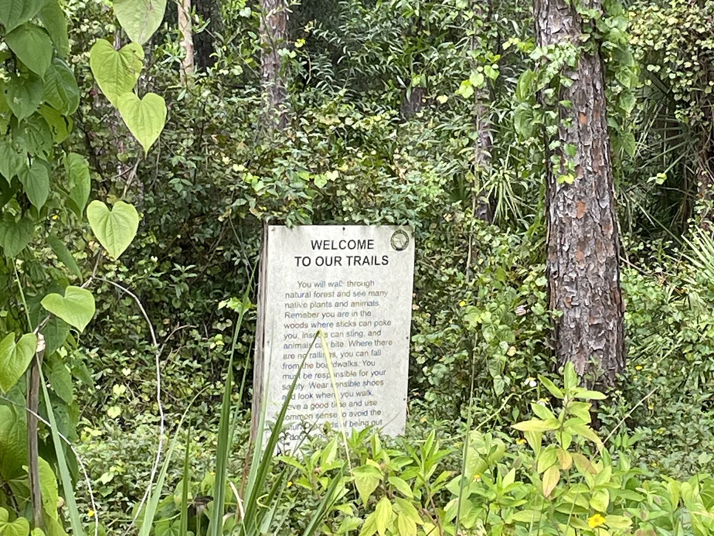 A welcome sign on the woodland trails at the Calusa Nature Center and Planetarium in Fort Myers, where the Haunted Walk runs.