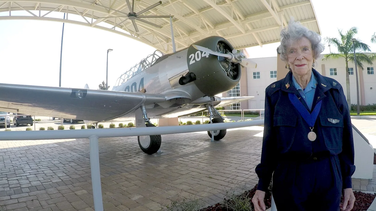 Bernice Haydu, a Women Airforce Service Pilot in World War II, beside an AT-6 Texan trainer at Page Field in Fort Myers.