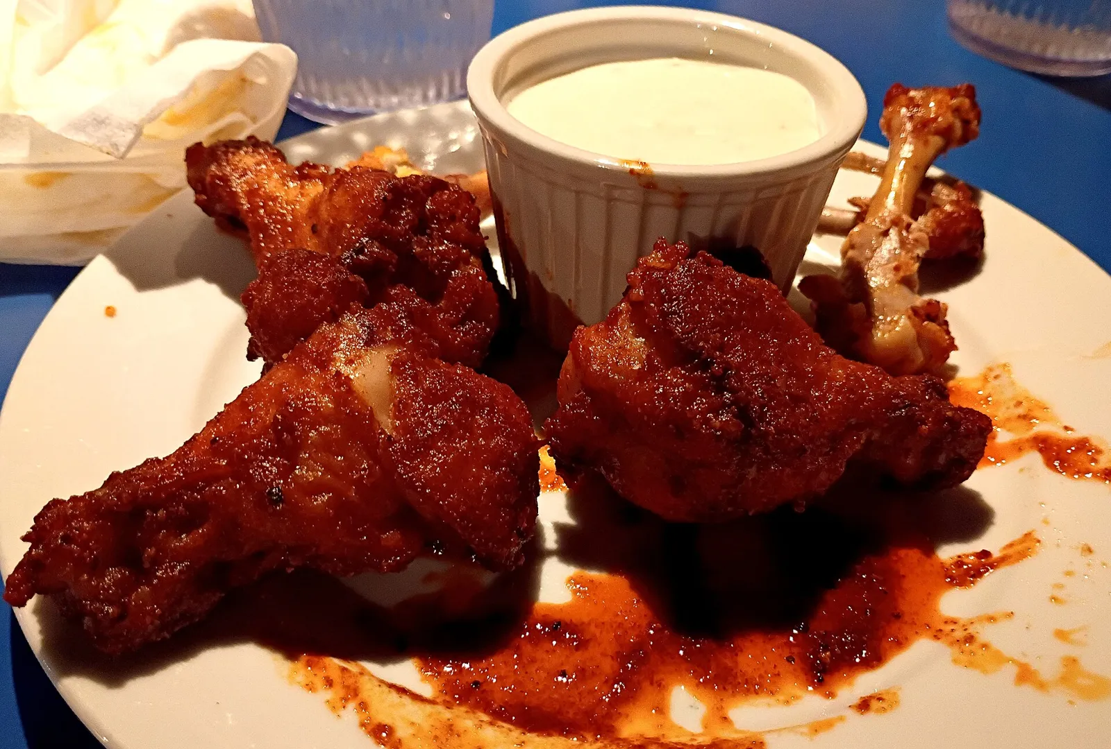 A plate of chicken wings with a cup of dressing. The photo was not taken at a Fort Myers restaurant.